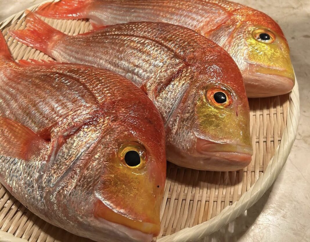 Whole red snapper on a woven tray